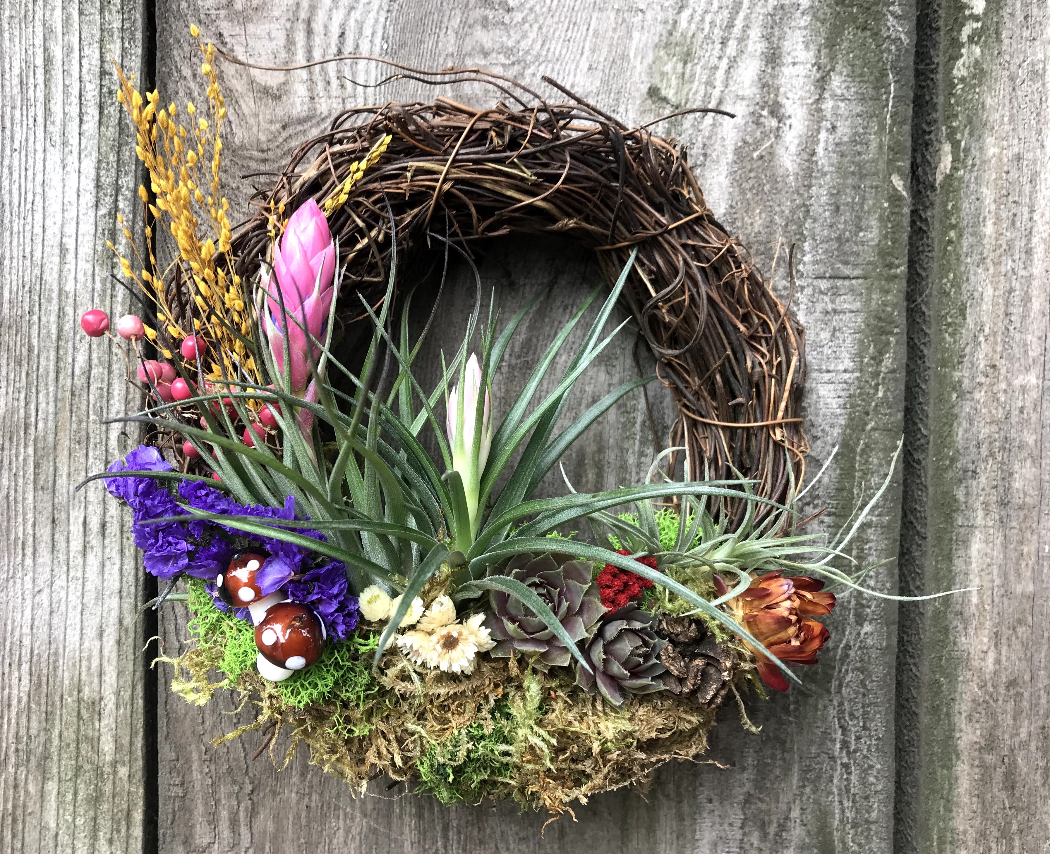 Handcrafted living wreath with plants and natural accents